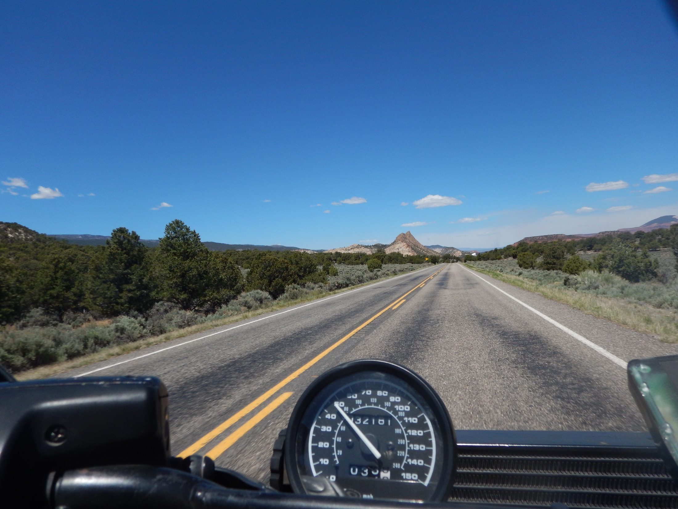 Open road viewed over motorcycle instruments